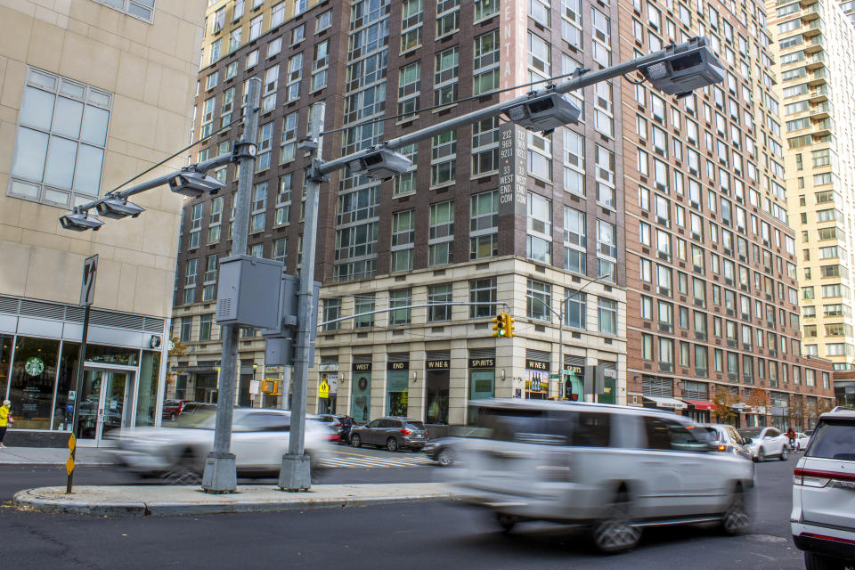 FILE - Recently installed toll traffic cameras stand above a Manhattan street, Friday, Nov. 16, 2023, in New York. Most drivers would pay $15 to enter Manhattan’s central business district under a plan released by New York officials Thursday, Nov. 30, 2023. The congestion pricing plan, which neighboring New Jersey has filed a lawsuit over, will be the first such program in the United States if it is approved by transportation officials early next year. (AP Photo/Ted Shaffrey, File)