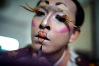 Teeraphong Meesat, 29, known as teacher Bally applies make up before his English class at the Prasartratprachakit School in Ratchaburi Province