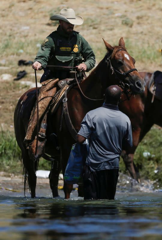 Migrants collecting food try to evade law enforcement at the U.S.-Mexico border