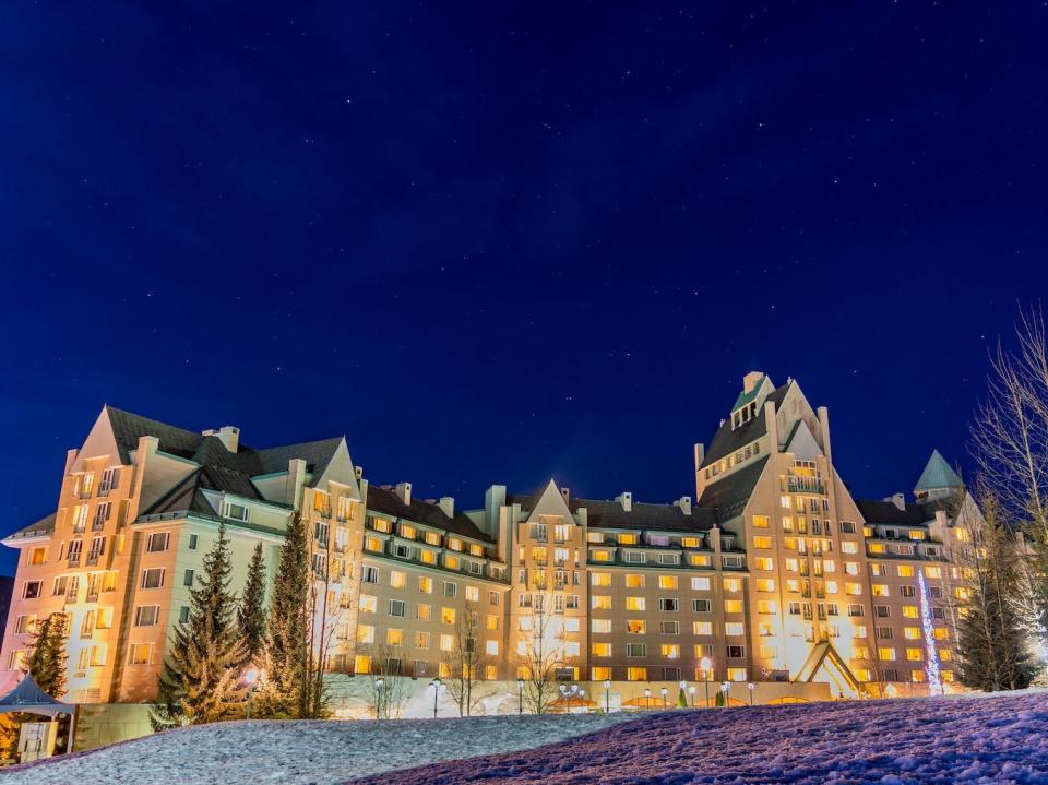 A luxurious hotel at night at the base of Whistler Mountain.