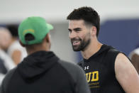 FILE - Quarterback Sam Hartman, a transfer from Wake Forest to Notre Dame, smiles as he talks with Notre Dame's wide receiver coach Chansi Stuckey during Notre Dame's NFL football Pro Day in South Bend, Ind., Friday, March 24, 2023. Notre Dame opens their season against Navy in Dublin, Ireland on Aug. 26. (AP Photo/Charles Rex Arbogast, File)