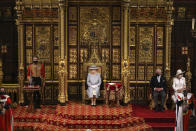 Britain's Queen Elizabeth II, with Prince Charles and Camilla, Duchess of Cornwall at right, delivers a speech in the House of Lords during the State Opening of Parliament at the Palace of Westminster in London, Tuesday May 11, 2021. (Chris Jackson/Pool via AP)