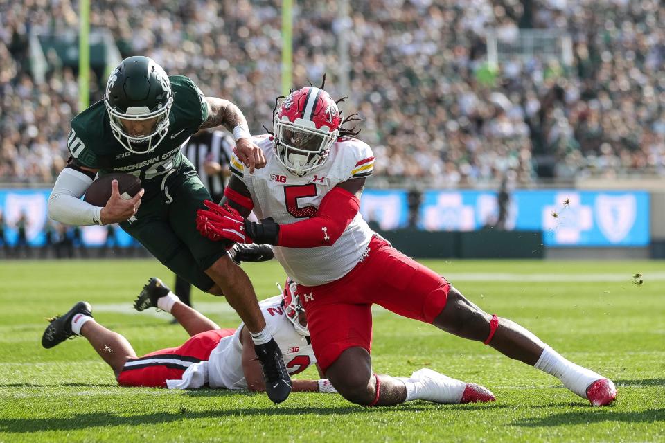 Michigan State quarterback Noah Kim (10) is tackled by Maryland defensive lineman Quashon Fuller (5) during the first half at Spartan Stadium in East Lansing on Saturday, Sept. 23, 2023.