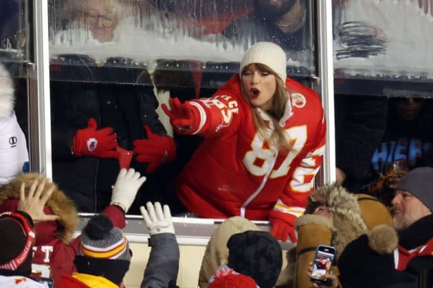 Taylor Swift celebrates with fans during the AFC Wild Card Playoffs between the Miami Dolphins and the Kansas City Chiefs at GEHA Field at Arrowhead Stadium on January 13, 2024 in Kansas City, Missouri. - Credit: Jamie Squire/Getty Images