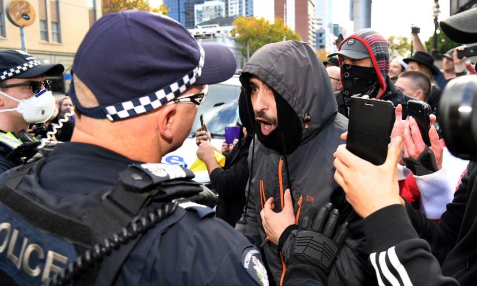 Police are confronted by anti-lockdown protesters. Source: Getty