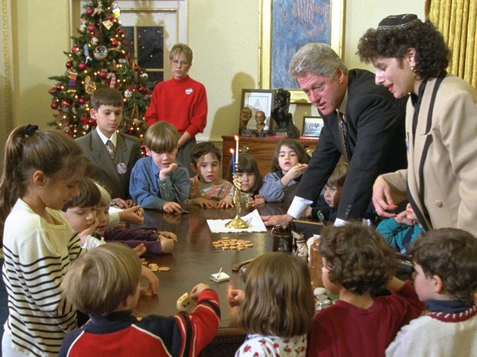 President Bill Clinton speaks with a group of children on Hanukkah.