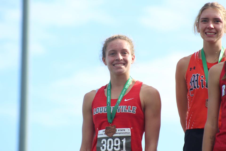 Loudonville's Tess Shultz all smiles with her medal, as she placed 10th at the Division III state cross country meet.