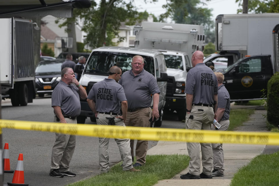 Authorities continue to work at the home of suspect Rex Heuermann in Massapequa Park, N.Y., Monday, July 24, 2023. Heuermann has been charged with killing at least three women in the long-unsolved slayings known as the Gilgo Beach killings. (AP Photo/Seth Wenig)