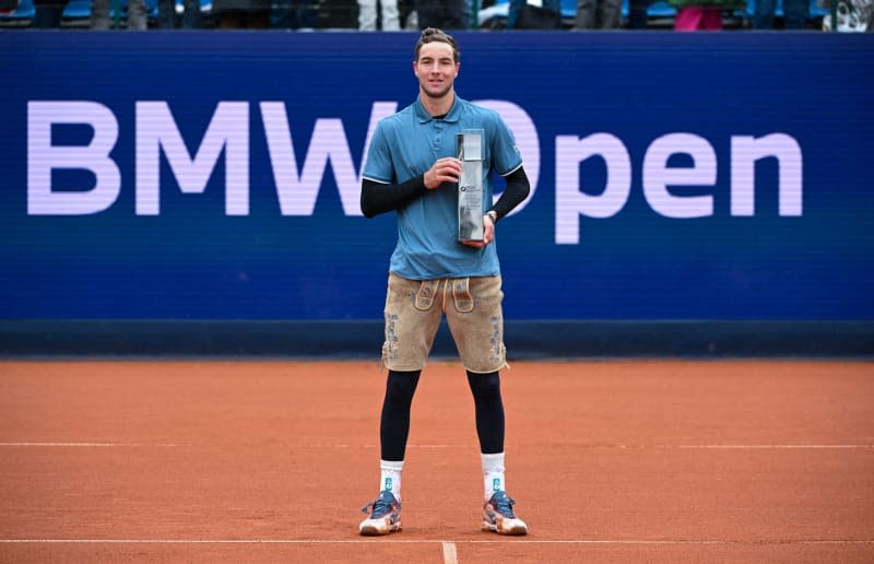 German tennis player Jan-Lennard Struff celebrates with the trophy after winning the men's singles final match against US Taylor Fritz at the Bavarian International Tennis Championships. Sven Hoppe/dpa