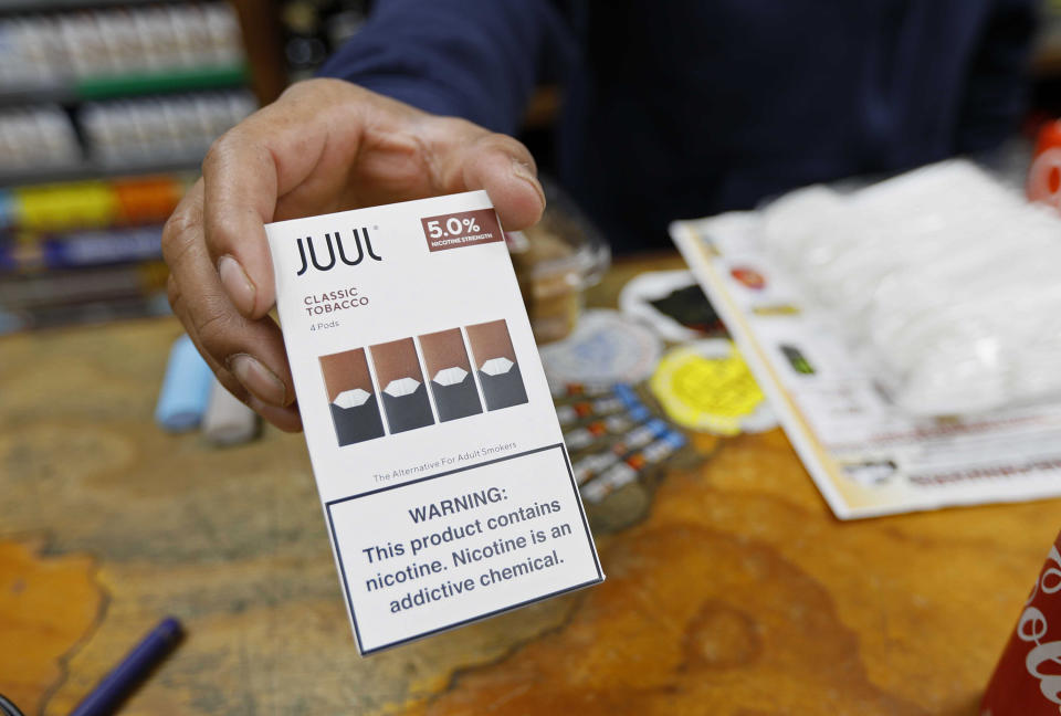 A San Francisco cashier displays a packet of tobacco-flavored Juul pods. San Francisco supervisors voted to ban all sales of electronic cigarettes in an effort to crack down on youth vaping, making it the first U.S. city to do so. (Photo: Samantha Maldonado/AP Photo)