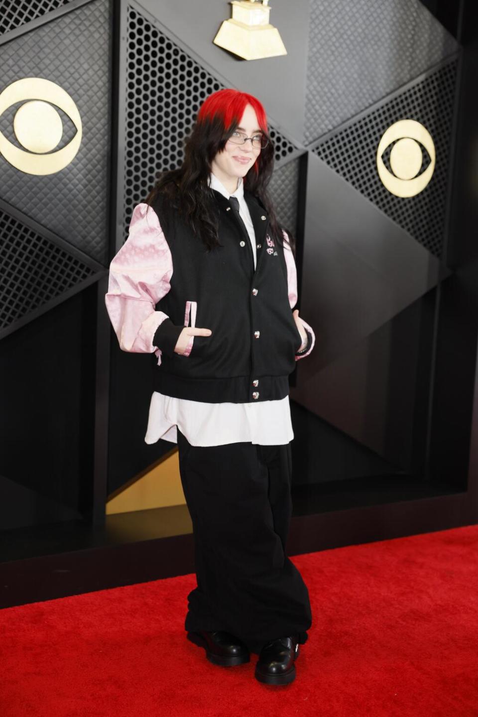 Billie Eilish wears a Barbie varsity jacket and black pants