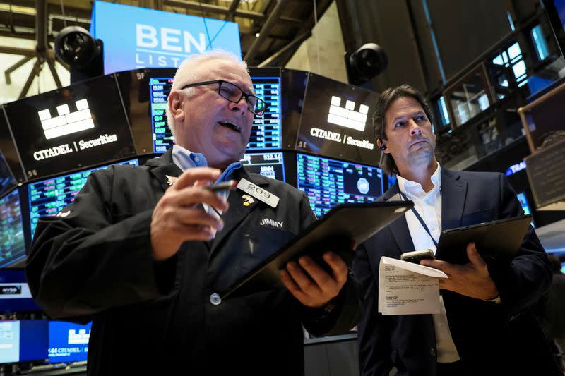 Traders work on the floor of the NYSE in New York