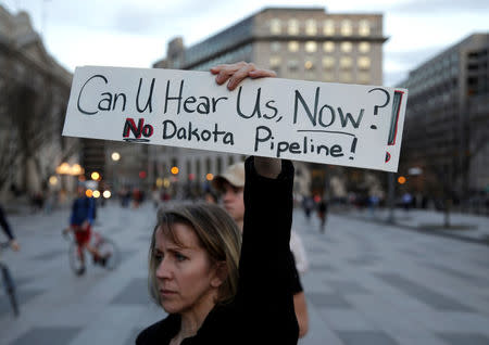 A woman protests against U.S. President Donald Trump's directive to permit the Dakota Access Pipeline during a demonstration at the White House in Washington, U.S., February 8, 2017. REUTERS/Joshua Roberts