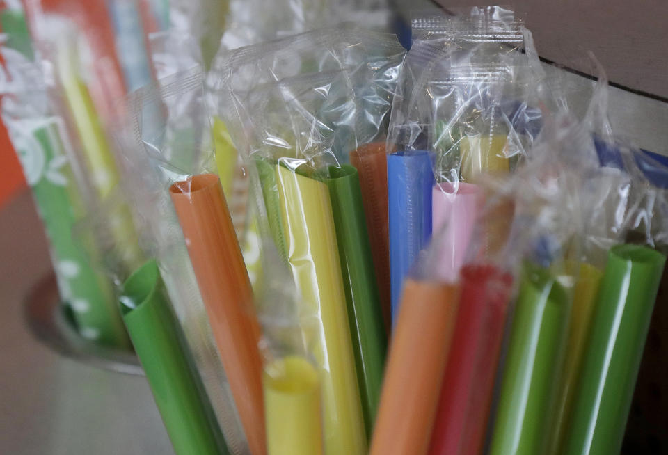 FILE - This July 17, 2018, file photo, shows wrapped plastic straws at a bubble tea cafe in San Francisco. Avoiding single-use plastics like straws, plastic bags and water bottles is easier than it seems and can feel empowering, say those who've managed to stop using them altogether. (AP Photo/Jeff Chiu, File)