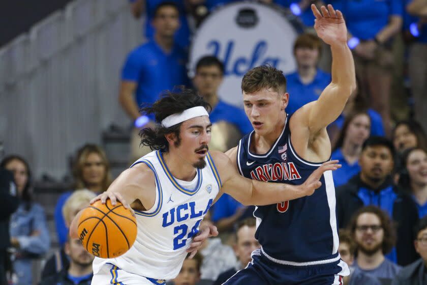 UCLA's Jaime Jaquez Jr. drives on Arizona's Pelle Larsson during the first half March 4, 2023, at Pauley Pavilion.