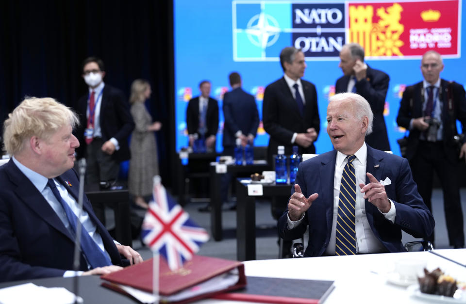 U.S. President Joe Biden, right, speaks with British Prime Minister Boris Johnson during a round table meeting at a NATO summit in Madrid, Spain on Thursday, June 30, 2022. North Atlantic Treaty Organization heads of state will meet for the final day of a NATO summit in Madrid on Thursday. (AP Photo/Bernat Armangue)