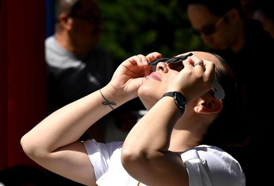 Lenny Santiago of Charlotte watches the solar eclipse from the Discovery Place parking deck.