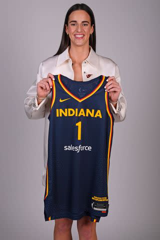 <p>Brian Babineau/NBAE via Getty</p> Caitlin Clark poses for a portrait after being selected first overall by the Indiana Fever during the 2024 WNBA Draft