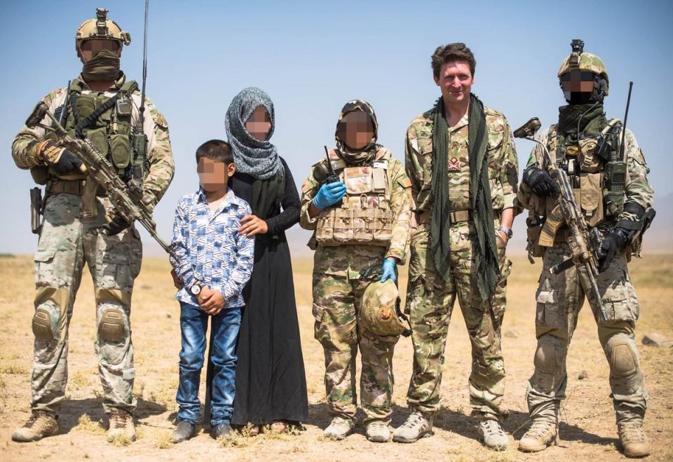 Major General Charlie Herbert (second right) with a female member of the Triples unit (Supplied)