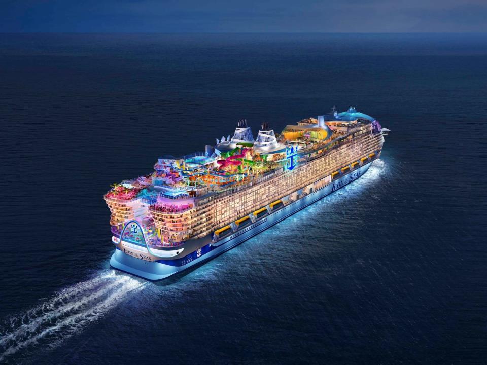 A rendering of the Icon of the Seas sailing in calm waters at night with its decks illuminated in a variety of colors.