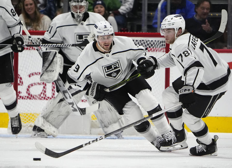 Los Angeles Kings right wing Alex Laferriere (78) collects the puck in front of right wing Adrian Kempe (9) in the second period of an NHL hockey game against the Colorado Avalanche, Friday, Jan. 26, 2024, in Denver. (AP Photo/David Zalubowski)