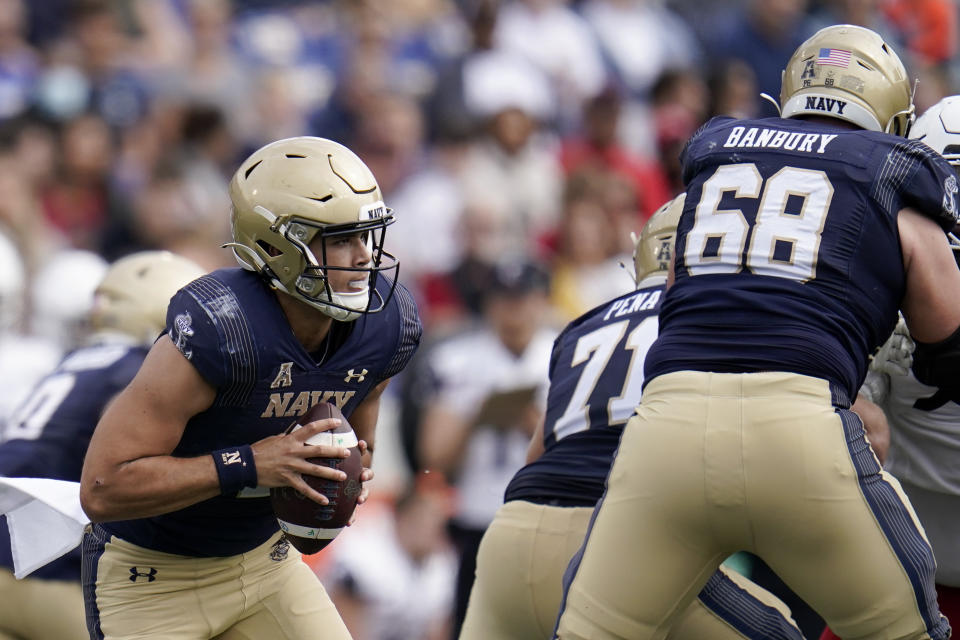 Navy quarterback Tai Lavatai runs withe the ball against Cincinnati during the first half of an NCAA college football game, Saturday, Oct. 23, 2021, in Annapolis, Md. (AP Photo/Julio Cortez)