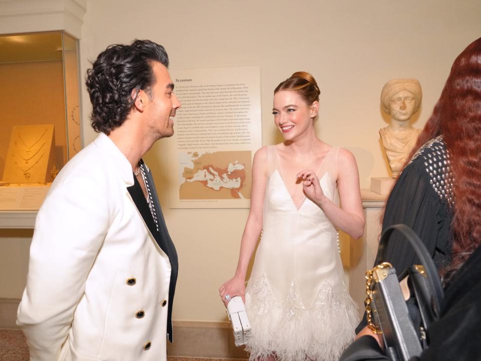 Joe Jonas and Emma Stone chat during the Met Gala on May 2, 2022.