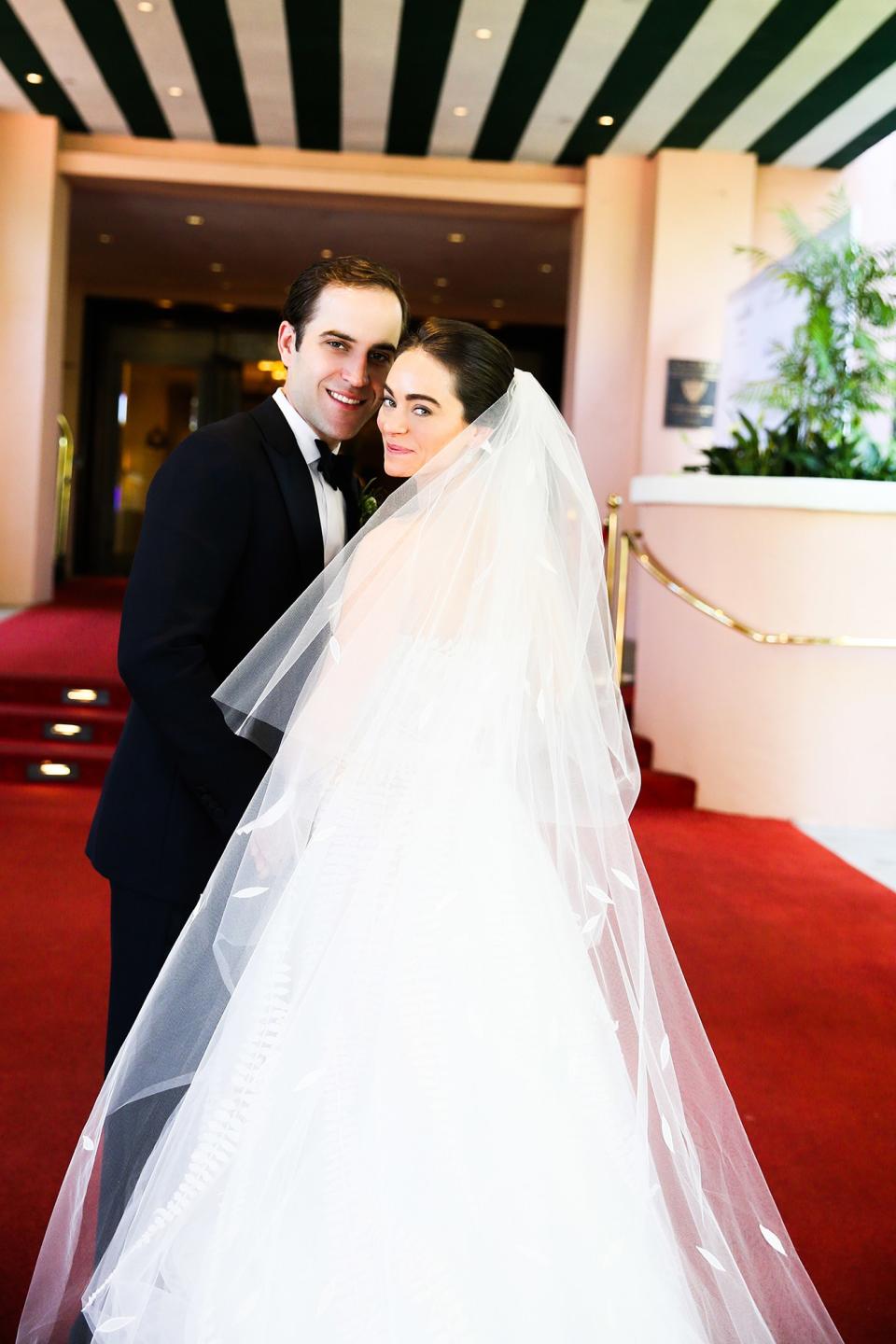 The bride wore Oscar de la Renta, inspired by her grandmother, for her greenery-filled ceremony at the Beverly Hills Hotel.