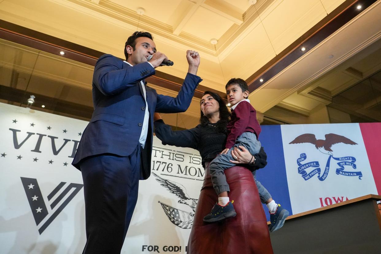 Republican Vivek Ramaswamy stands with his family as he ends his presidential bid and endorses former President Donald Trump in Des Moines on Monday.