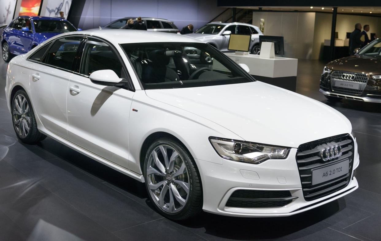 Brussels, Belgium - January 14, 2014: White Audi A6 2.0 Turbo Diesel Berline four door executive sedan on display at the Brussels motor show. People in the background are looking at the cars.