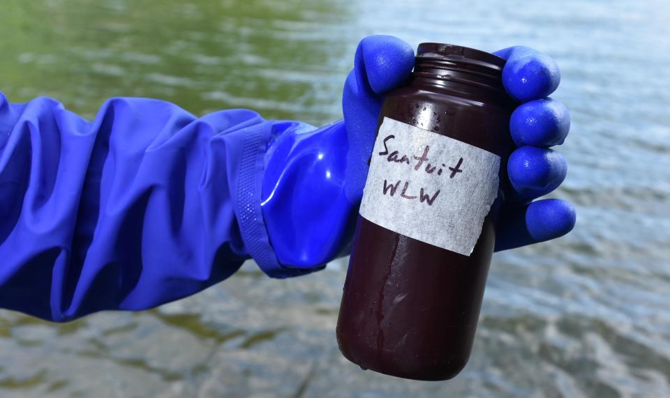 Association to Preserve Cape Cod's Rebecca Miller collected a water sample at Santuit Pond in 2019, where a bloom of cyanobacteria closed the pond to swimming at the time. File photo