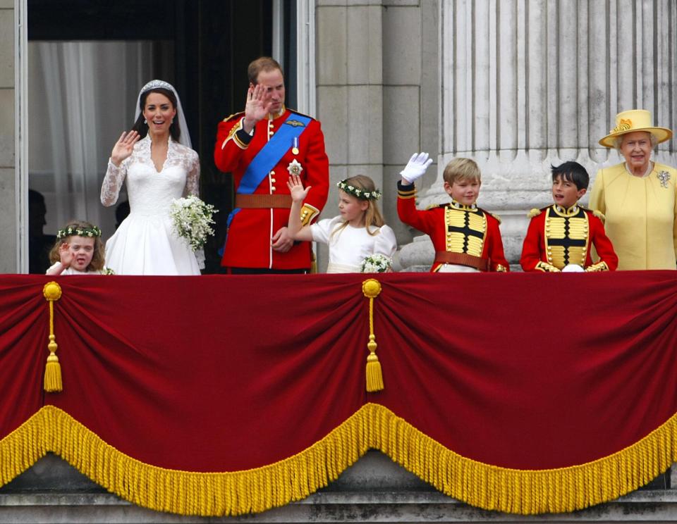 Prince William and his wife Kate Middleton, who has been given the title of The Duchess of Cambridge, greet the crowds along with Queen Elizabeth II (right) on the balcony of Buckingham Palace, London, following their wedding at Westminster Abbey.