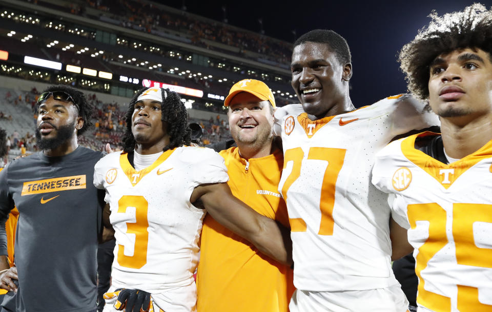 Tennessee head coach Josh Heupel, center, celebrates with his team after defeating Oklahoma in an NCAA college football game Saturday, Sept. 21, 2024, in Norman, Okla. (AP Photo/Alonzo Adams)