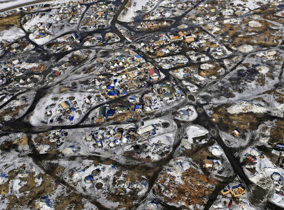 FILE - This Feb. 13, 2017 aerial photo shows the Oceti Sakowin camp, where people have gathered to protest the Dakota Access pipeline on federal land in Cannon Ball, N.D. South Dakota Gov. Kristi Noem says she's proposing legislation ahead of the Keystone XL oil pipeline's construction that would create a legal avenue to pursue out-of-state money that funds protests aimed at slowing construction. Noem's bills come after opponents of the Dakota Access oil pipeline staged large protests that resulted in 761 arrests in southern North Dakota over a six-month span beginning in late 2016. The state spent tens of millions of dollars policing the protests. (Tom Stromme/The Bismarck Tribune via AP, File)