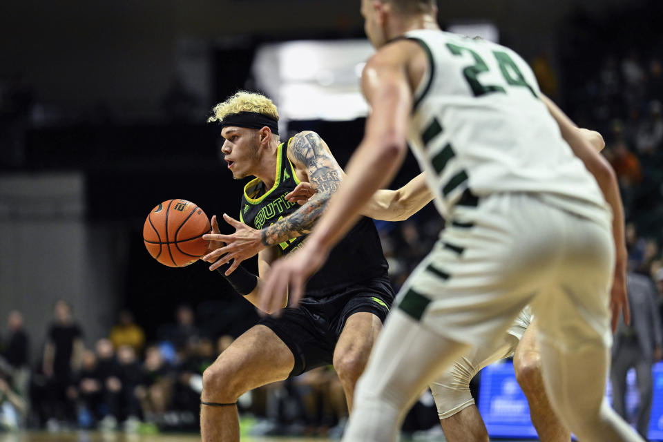 South Florida forward Kasean Pryor drives to the basket during the first half of an NCAA college basketball game against Charlotte on Saturday, March 2, 2024, in Charlotte, N.C. (AP Photo/Matt Kelley)