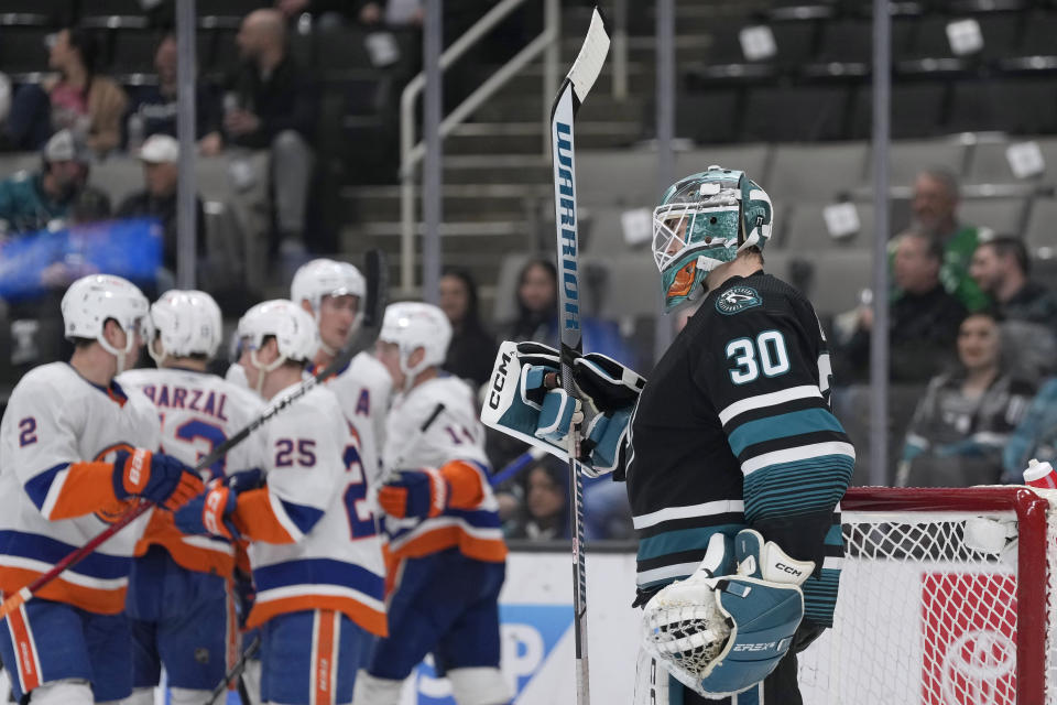 San Jose Sharks goaltender Magnus Chrona (30) waits as New York Islanders celebrate a goal by defenseman Sebastian Aho (25) during the second period of an NHL hockey game in San Jose, Calif., Thursday, March 7, 2024. (AP Photo/Jeff Chiu)