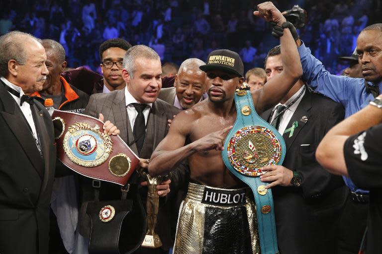 Floyd Mayweather celebrates after defeating Manny Pacquiao in their welterweight unification boxing bout at the MGM Grand Garden Arena in Las Vegas on May 2, 2015