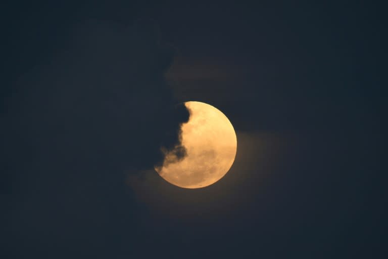 The full moon rises from Legazpi City in the Philippines