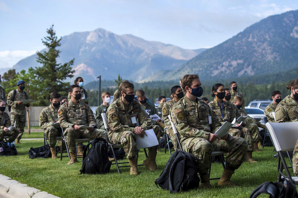 In this image provided by the U.S. Air Force Academy, academy cadets start the school year with a class held outdoors on Aug. 12, 2020 at the U.S. Air Force Academy in Colorado Springs, Colo. Under the siege of the coronavirus pandemic, classes have begun at the Naval Academy, the Air Force Academy and the U.S. Military Academy at West Point. But unlike at many colleges around the country, most students are on campus and many will attend classes in person. (Trevor Cokley/U.S. Air Force Academy via AP)
