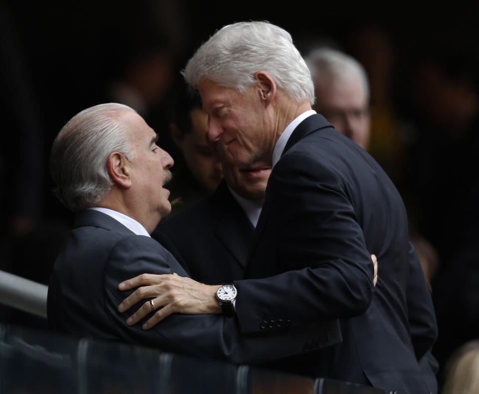 Former U.S. President Bill Clinton, right, greets, Former Colombian President Andrés Pastrana before the memorial service for former South African president Nelson Mandela at the FNB Stadium in Soweto near Johannesburg, Tuesday, Dec. 10, 2013. (AP Photo/Ben Curtis)