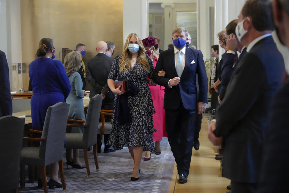 Heir to the Dutch throne Princess Amalia, center left, is escorted by her father King Willem-Alexander after she took an honorary seat at the Council of State, the highest government advisory body in The Hague, Netherlands, Wednesday, Dec. 8, 2021, one day after celebrating her eighteenth birthday. (AP Photo/Peter Dejong, Pool)