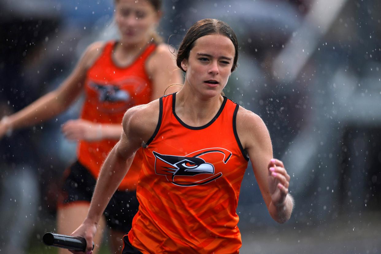 Charlotte's Kallie Nichols takes the baton in her leg of the 4x200 meter relay during the MHSAA track and field 15-2 regional, Friday, May 19, 2023, at Mason High School.