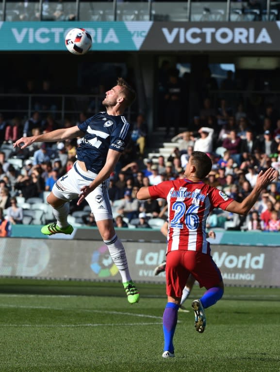 Melbourne Victory's Nicholas Ansell leaps for the ball during the match against Atletico Madrid near Melbourne on July 31, 2016