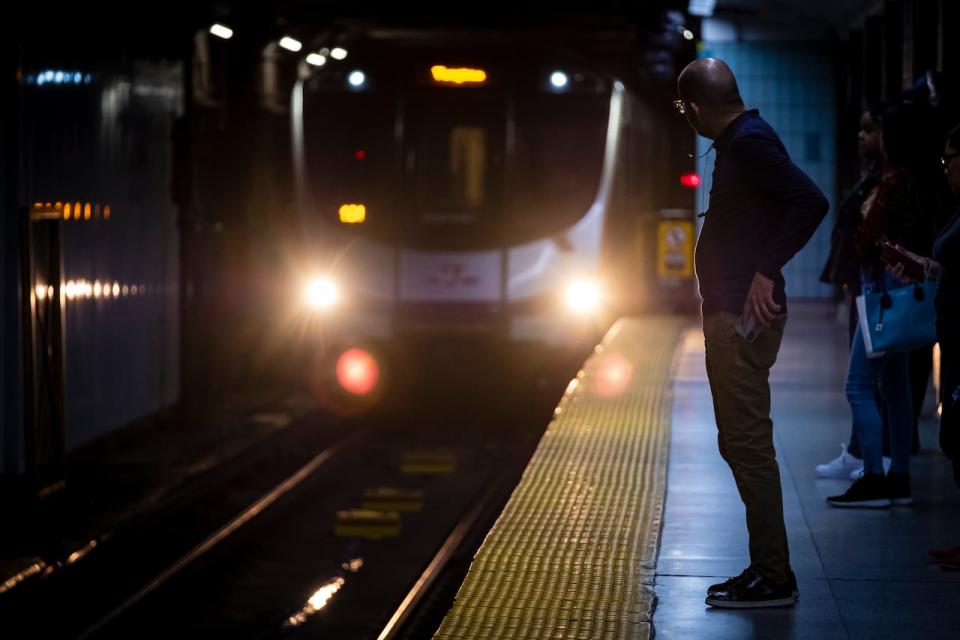 The Toronto Transit Commission is speaking out in the hopes of preventing subway suicides. It’s a move that represents a break from a decades long policy of silence about deaths on the tracks. See train approaching station as man watches at end of platform.