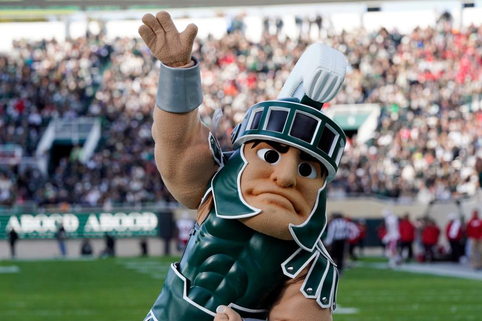 Sparty, the Michigan State mascot, waves to the crowd during the first half against Wisconsin, Saturday, Oct. 15, 2022, in East Lansing.