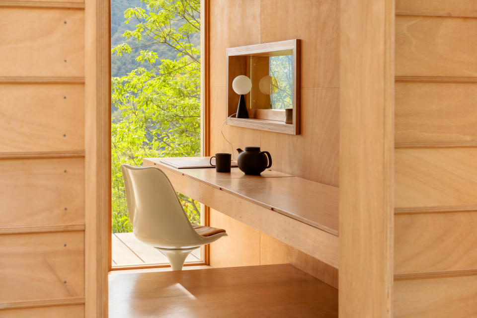 wooden built in desk in a tiny house