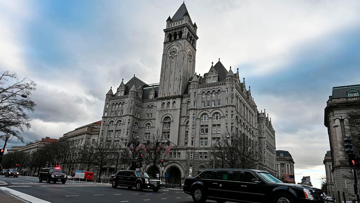 A motorcade speeds down Pennsylvania Avenue past what was once the International Trump Hotel in Washington, D.C., on Jan. 24, 2019.