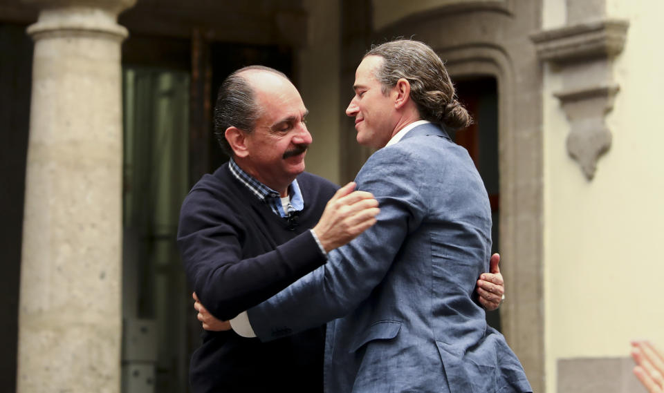 Federico Acosta, a Mexican who traces his lineage back 16 generations back to Moctezuma's daughter, left, embraces Italian Ascanio Pignatelli also of the 16th generation descended from Hernan Cortes' daughter, during a press conference in Mexico City, Friday, Nov. 8, 2019. Descendants of the Spanish conquistador and the Aztec emperor are meeting in Mexico City to mark the 500th anniversary of their forbearers' first encounter. The hope was that this meeting, at a colonial church where Cortes is buried, would go better than the one 500 years ago. (AP Photo/Eduardo Verdugo)