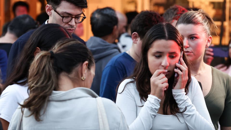 People react outside the Westfield Bondi Junction shopping mall after a stabbing incident in Sydney on April 13, 2024. - David Gray/AFP/Getty Images