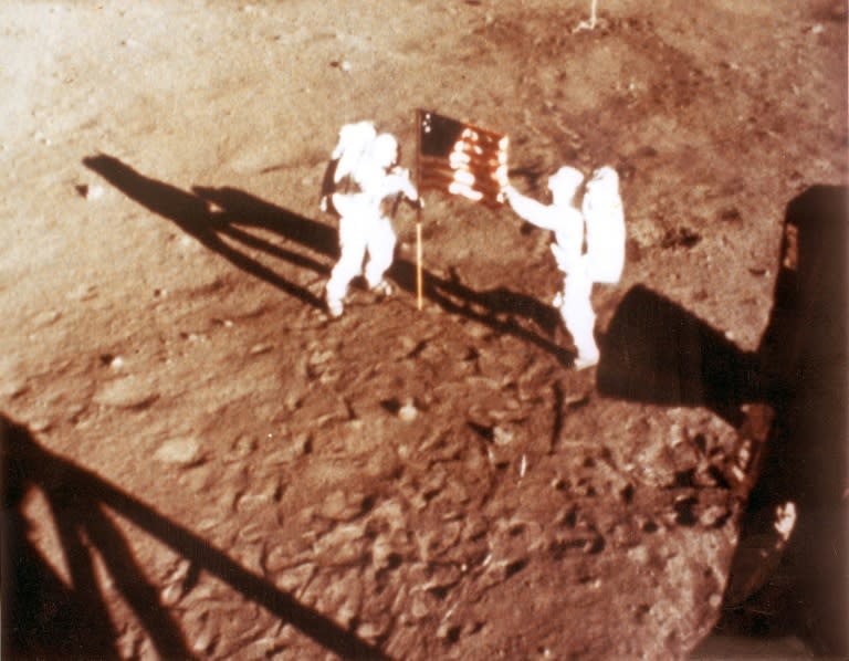 NASA photo taken on July 20, 1969 shows US astronauts Neil Armstrong and "Buzz" Aldrin deploying the US flag on the lunar surface during the Apollo 11 mission